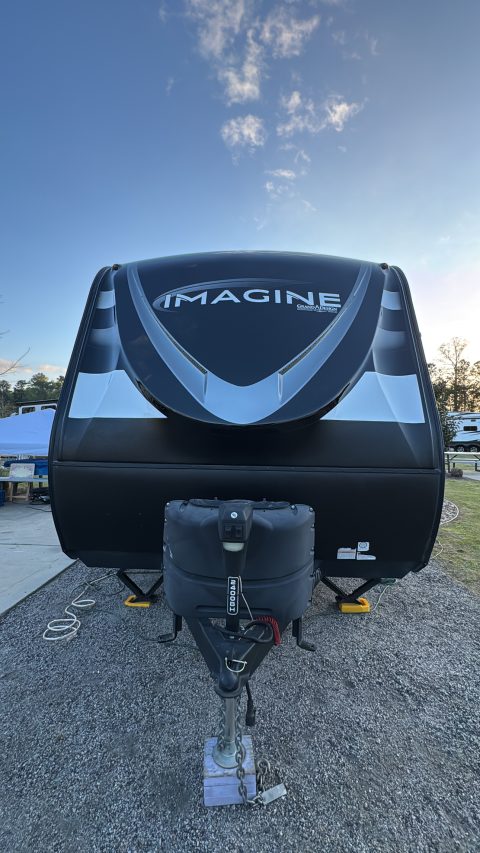 Grand Design Imagine travel trailer front cap sealed with a ceramic coating, photographed at dusk