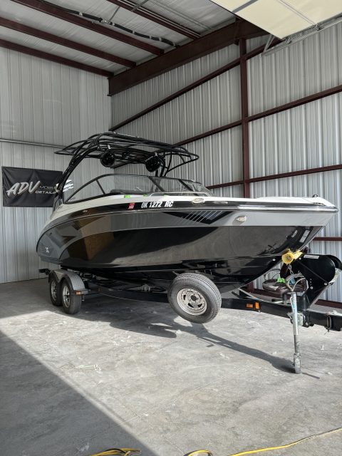 Black and silver Yamaha 242 wake boat on its trailer inside the ADV Mobile Detailing shop in Oklahoma City