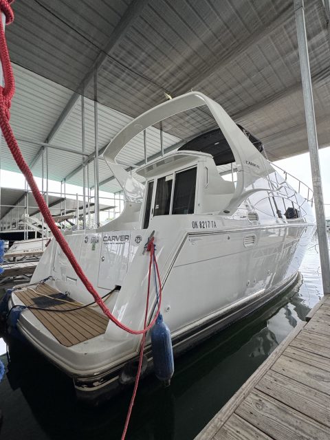 Carver 350 Mariner cabin cruiser moored in a covered slip after a wash and hull detail