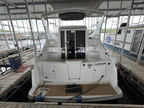 Stern and teak swim platform of a Carver 350 Mariner tied off at an Oklahoma lake dock