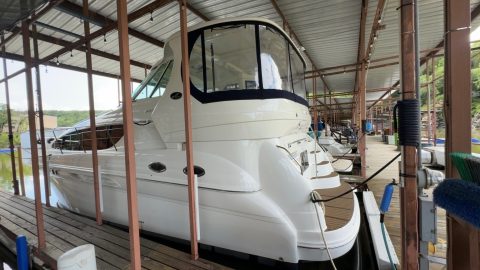 White Sea Ray cruiser in a covered boat slip after a wash down and hull detail