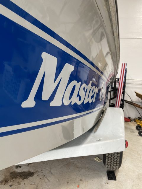 Close view of a blue and white MasterCraft hull stripe polished to a clean, even gloss