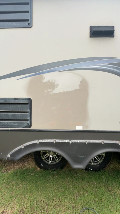 Polished section of RV sidewall showing restored gloss against the surrounding chalky, oxidized gelcoat